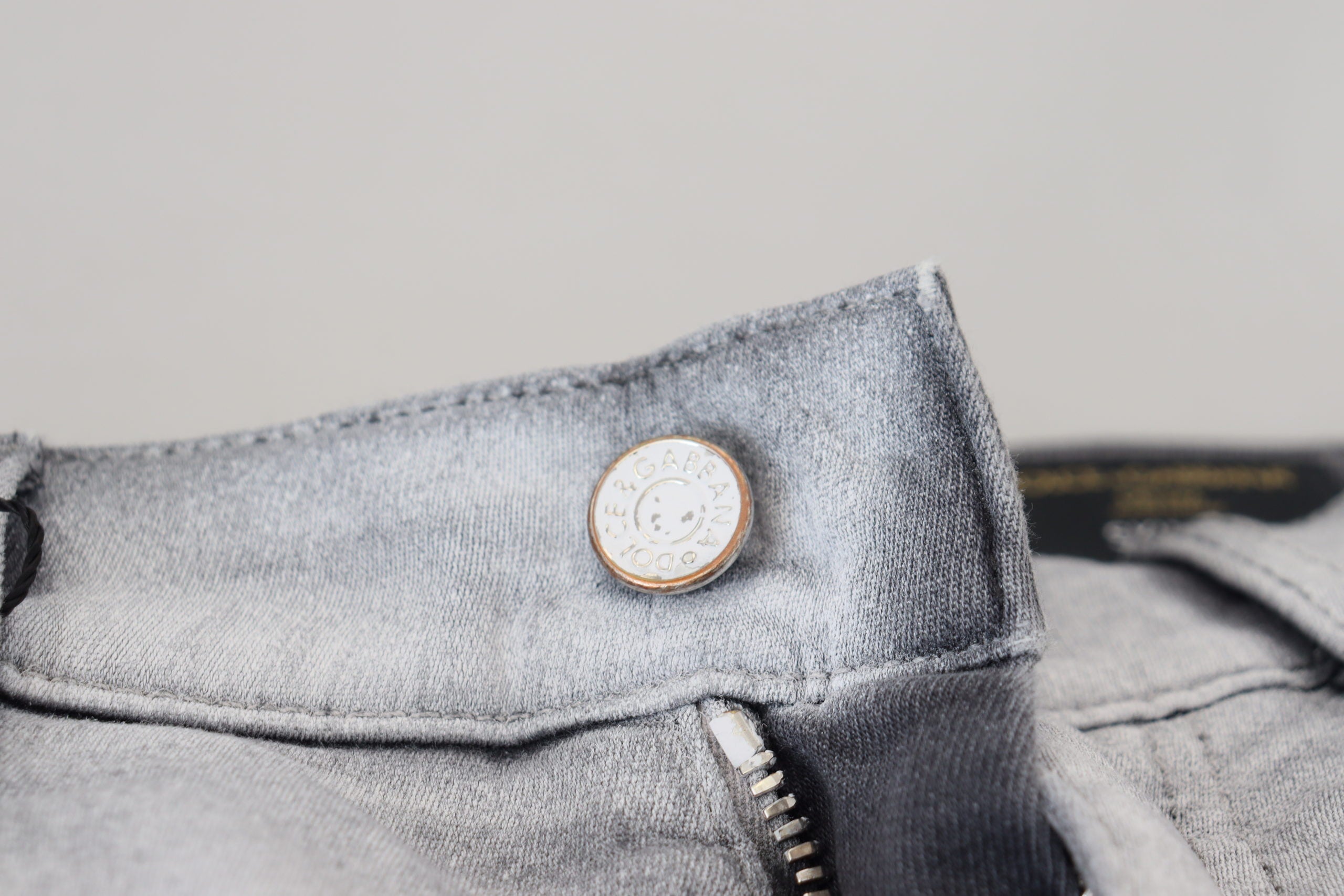 Gray washed skinny men's denim jeans by Dolce & Gabbana, showing close-up of fitted style and textured fabric.