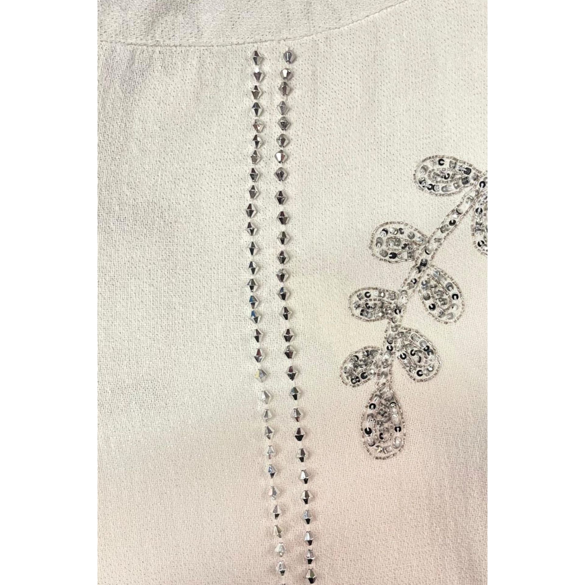 White Trussardi Jeans with classic design, displayed on a hanger, showcasing the high-quality denim and brand label.