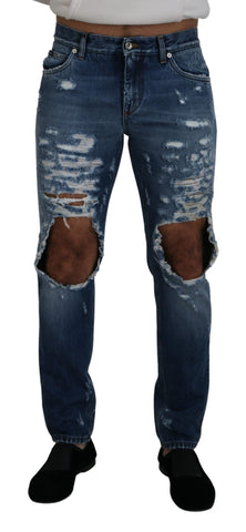 Blue cotton tattered men's denim jeans by Dolce & Gabbana, showing distressed fabric and classic denim style.