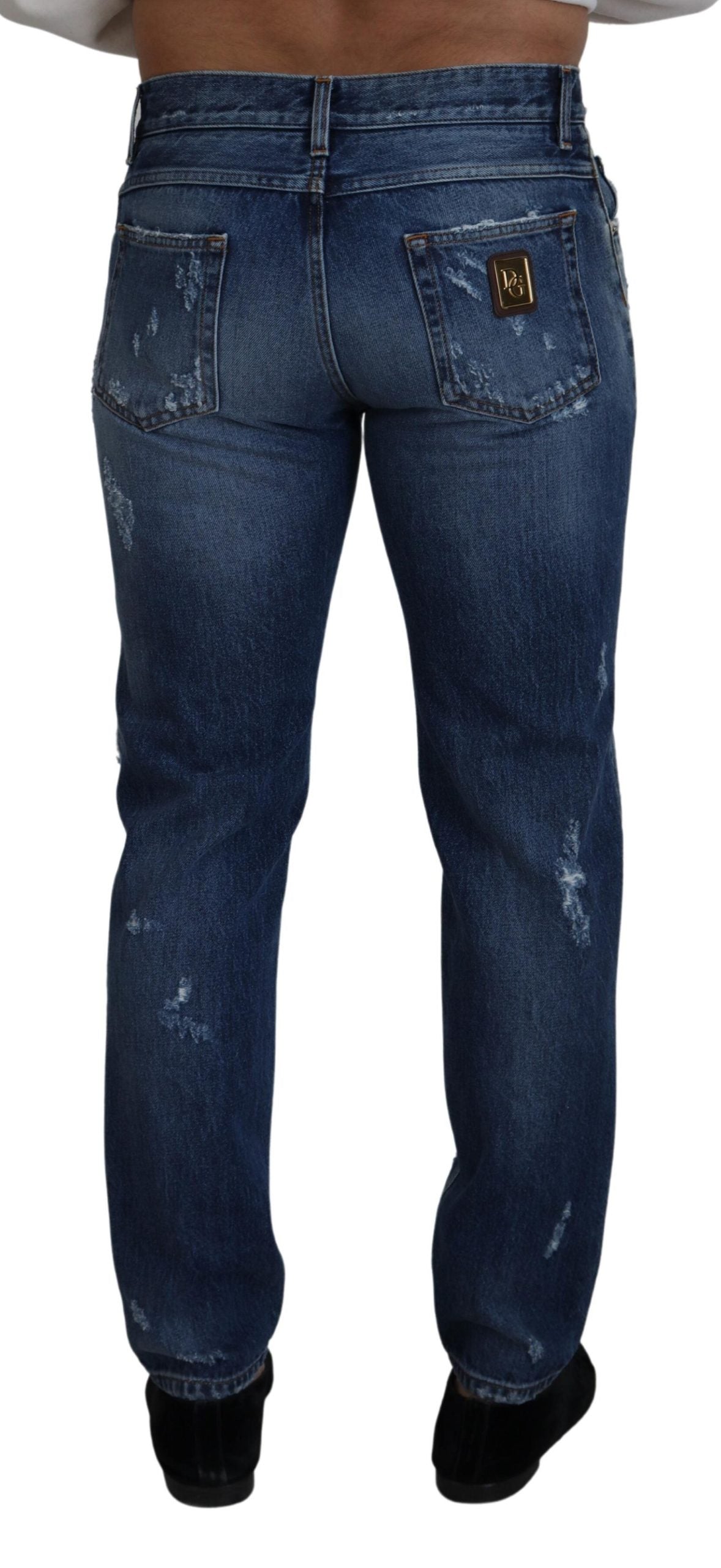Blue cotton tattered men's denim jeans by Dolce & Gabbana, showing distressed details and classic fit.