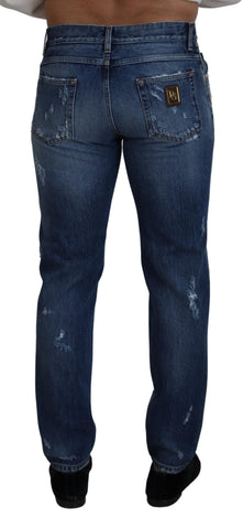 Blue cotton tattered men's denim jeans by Dolce & Gabbana, showing distressed details and classic fit.
