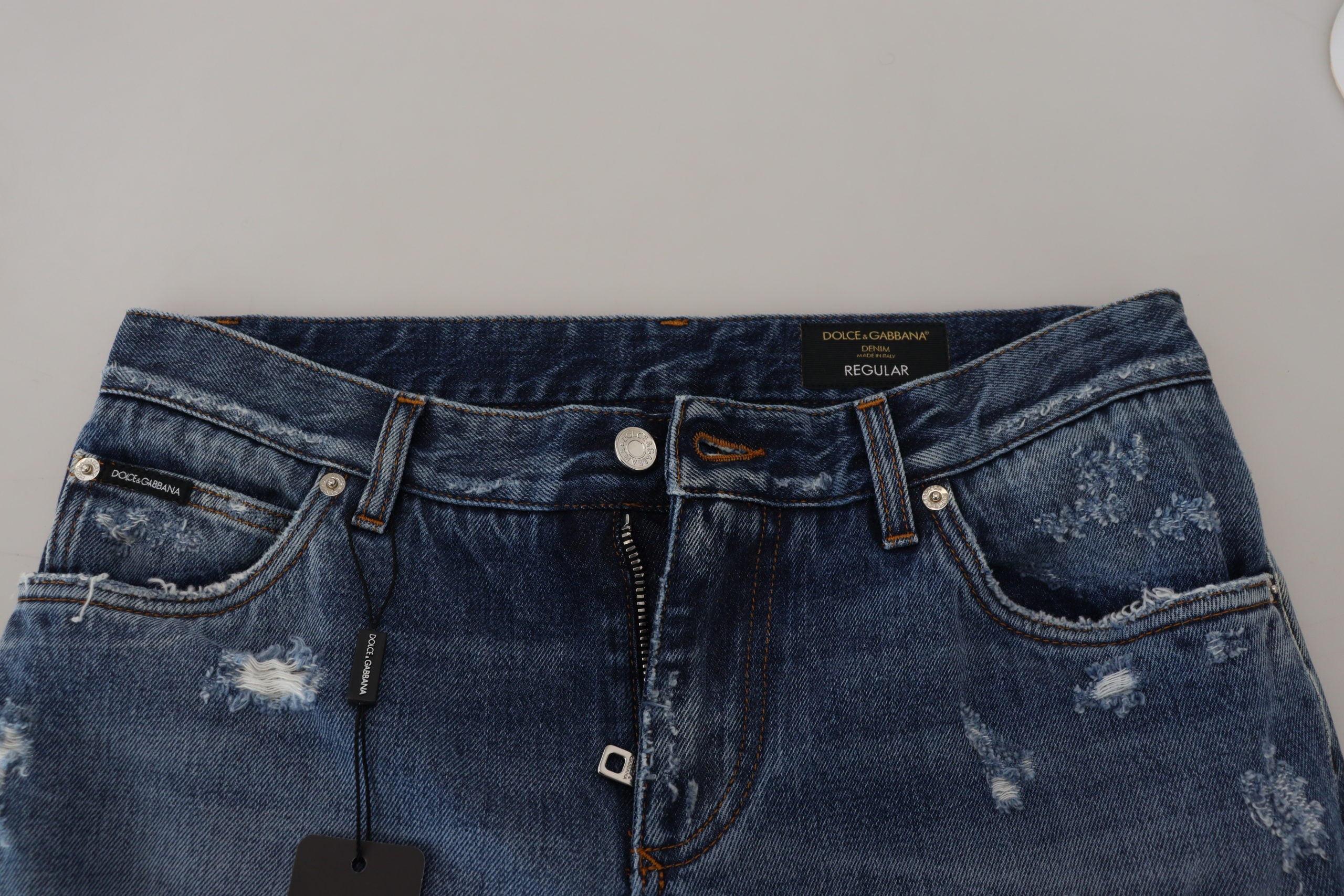 Blue cotton denim jeans for men with a tattered design by Dolce & Gabbana, shown in front view.