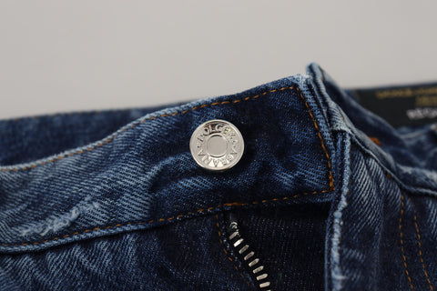 Blue cotton tattered men's denim jeans by Dolce & Gabbana, showcasing distressed fabric and classic fit.
