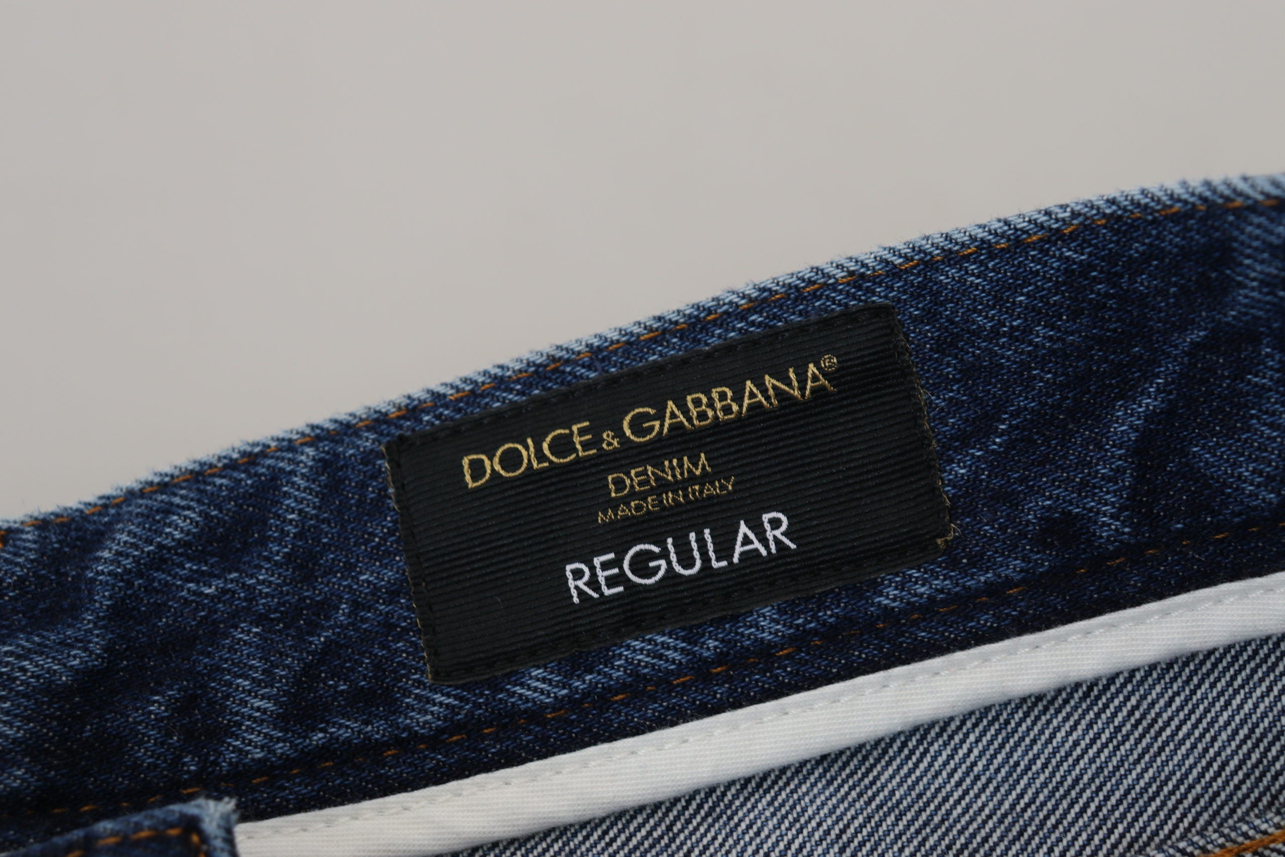 Blue cotton tattered men's denim jeans by Dolce & Gabbana, showing distressed fabric and classic denim style.
