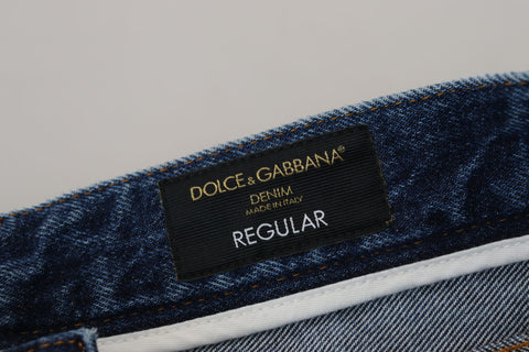 Blue cotton tattered men's denim jeans by Dolce & Gabbana, showing distressed fabric and classic denim style.