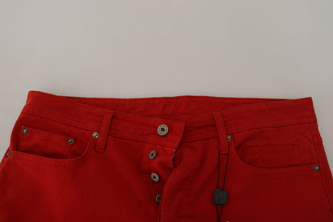 Red cotton straight fit men's denim jeans by Dolce & Gabbana, shown on a hanger with front pockets and classic stitching.