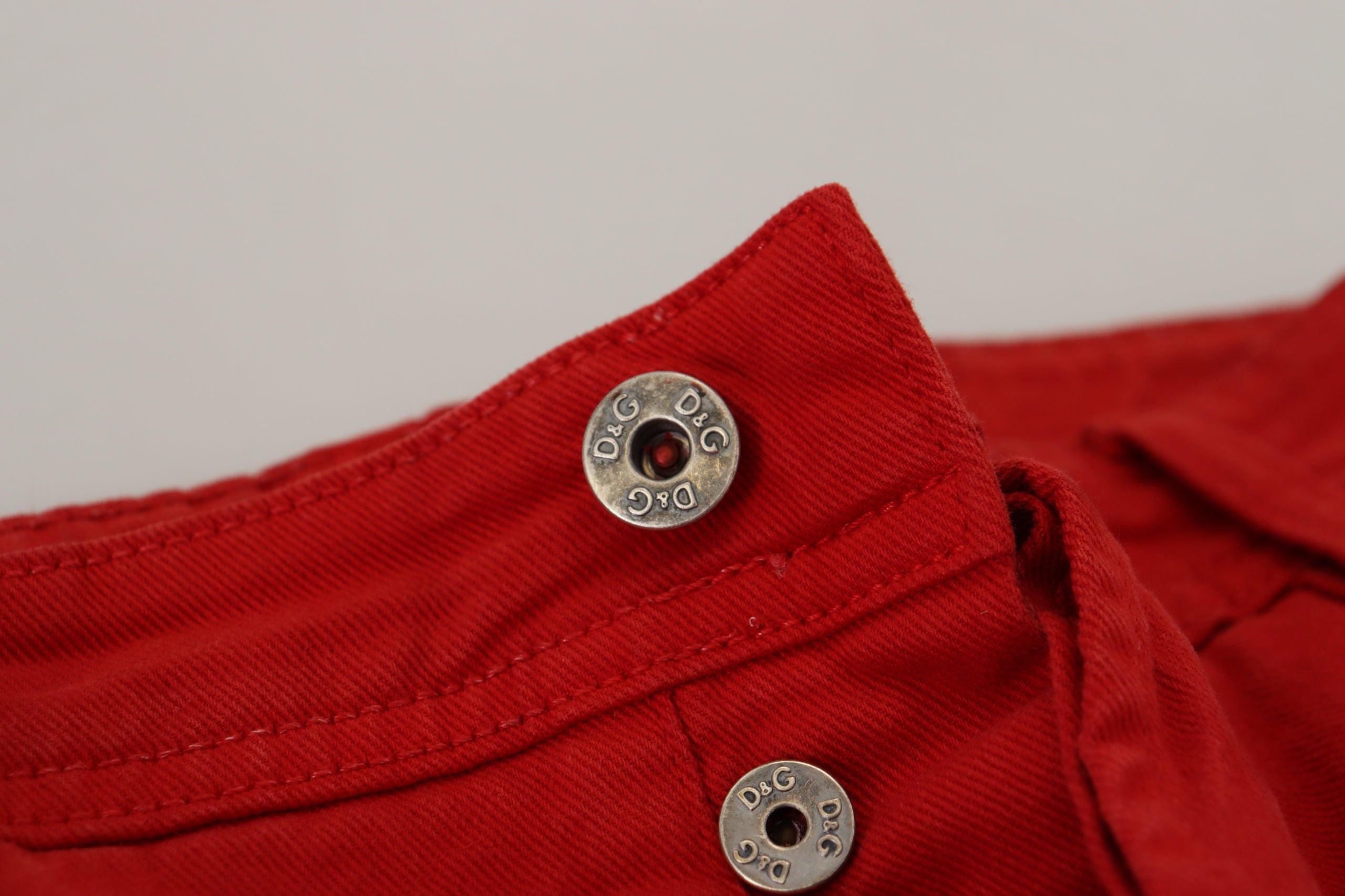 Red cotton straight fit men's denim jeans by Dolce & Gabbana, shown with front pockets and classic stitching.