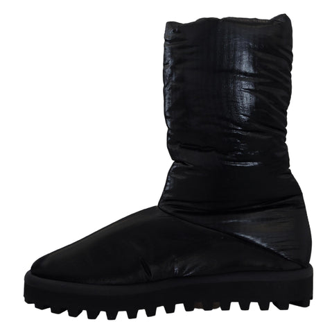 Black padded mid-calf winter boots by Dolce & Gabbana featuring a sleek design and sturdy sole.