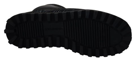 Black padded mid calf winter boots by Dolce & Gabbana with thick soles and stylish design, perfect for cold weather.