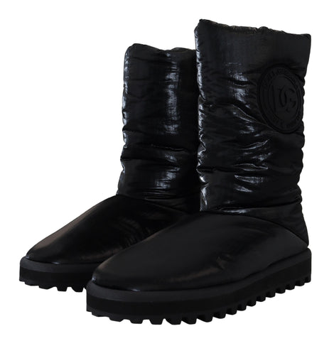 Black padded mid-calf winter boots by Dolce & Gabbana with chunky soles and stylish design, suitable for cold weather.