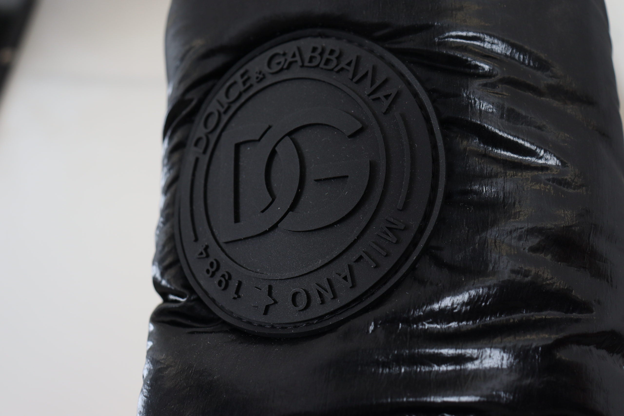 Black padded mid-calf winter boots by Dolce & Gabbana featuring a sleek design and sturdy sole for cold weather wear.