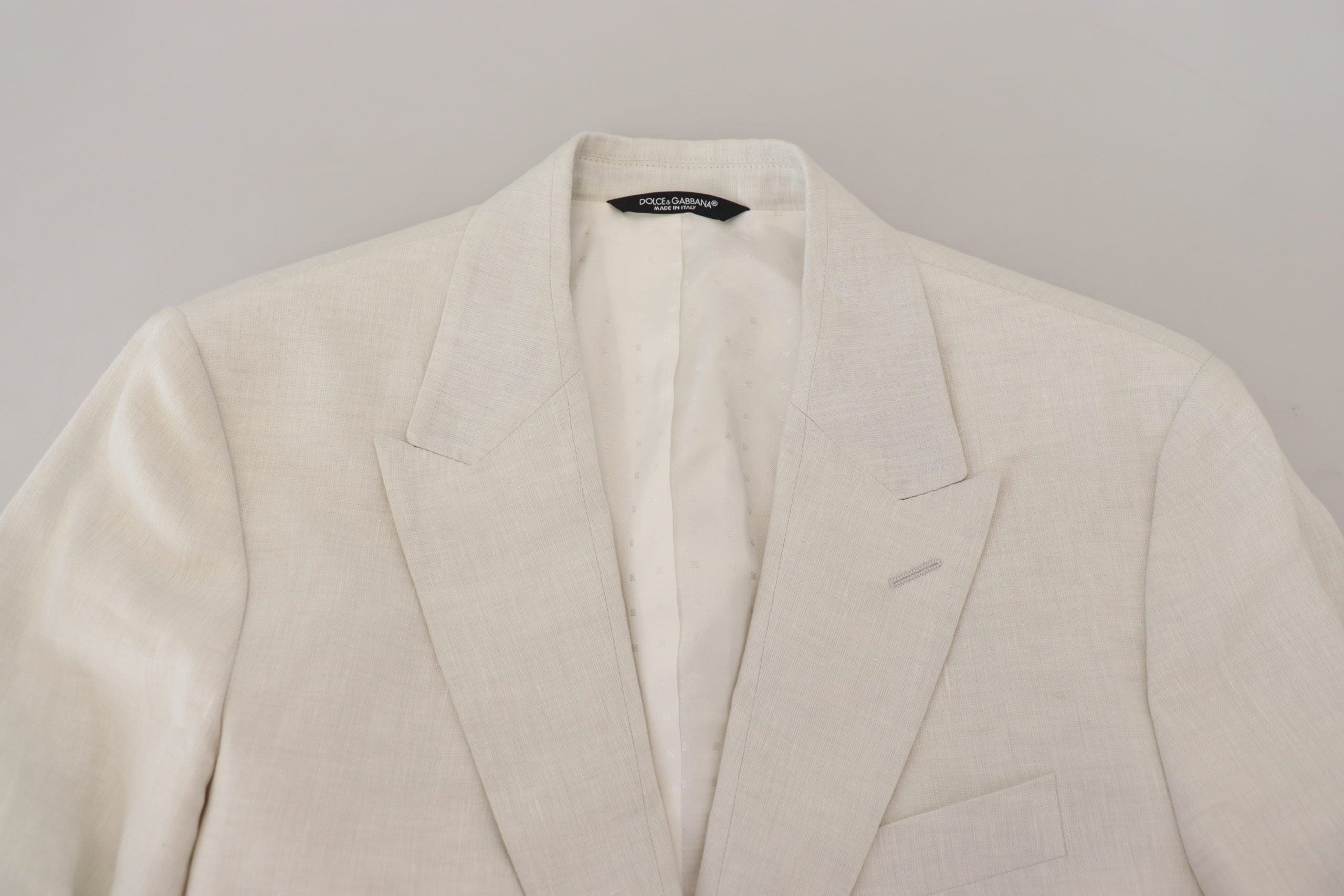 White linen slim fit blazer jacket by Dolce & Gabbana, tailored with a sleek design and classic lapel for a sophisticated look.