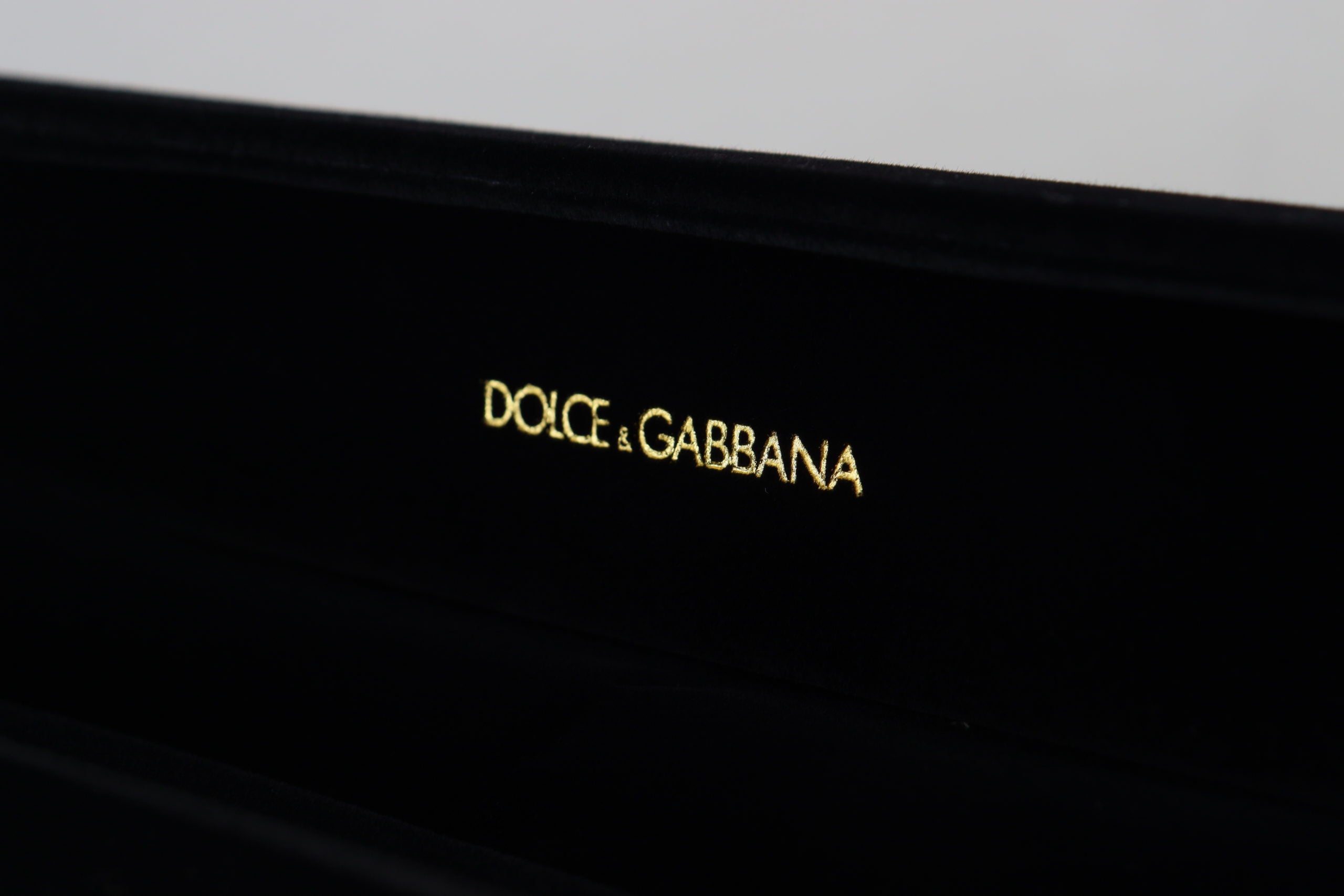 Black velvet jewelry box with Dolce & Gabbana logo plaque, designed for storing bracelets and jewelry securely.