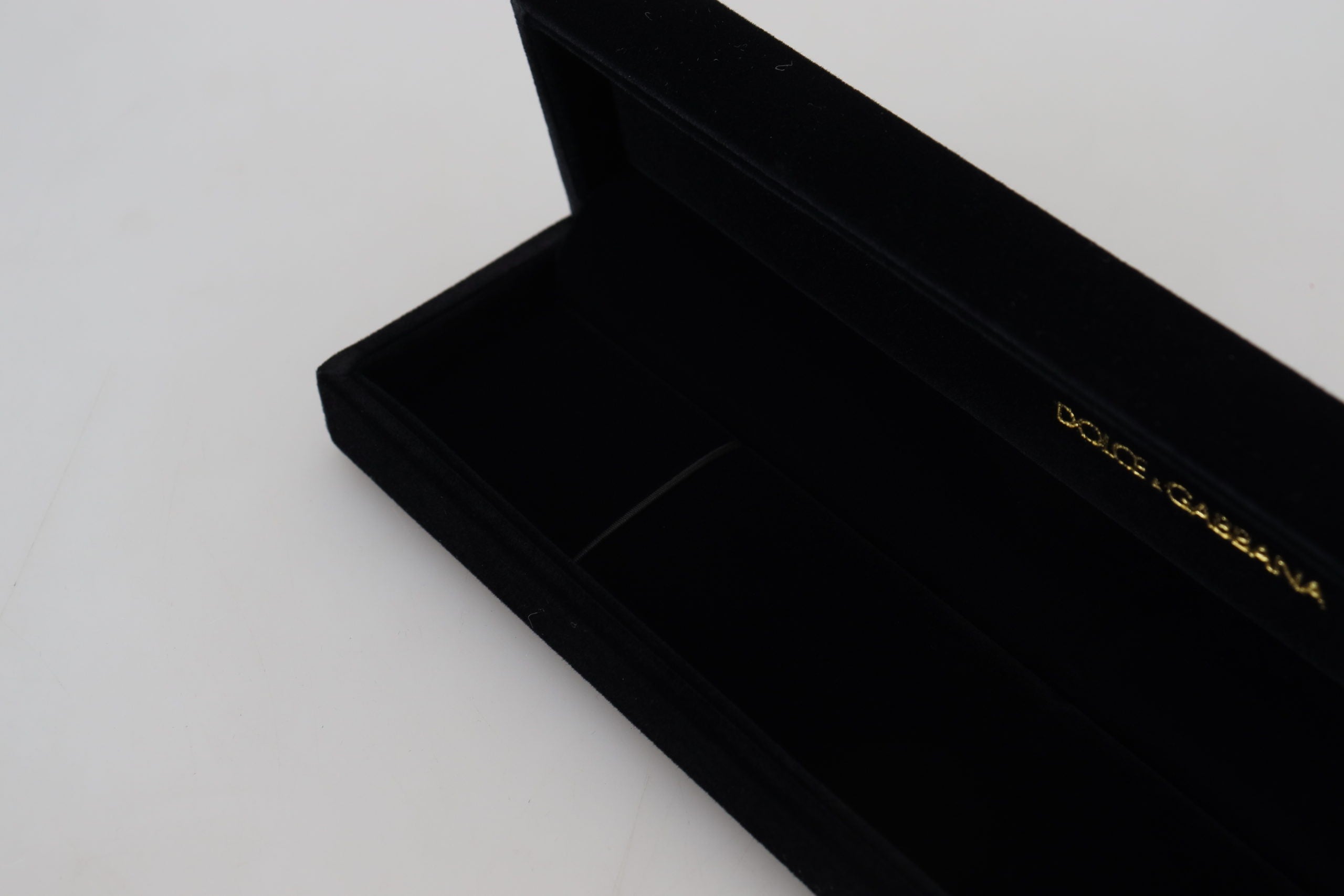 Black velvet jewelry box with Dolce & Gabbana logo plaque, designed for storing bracelets and jewelry securely.