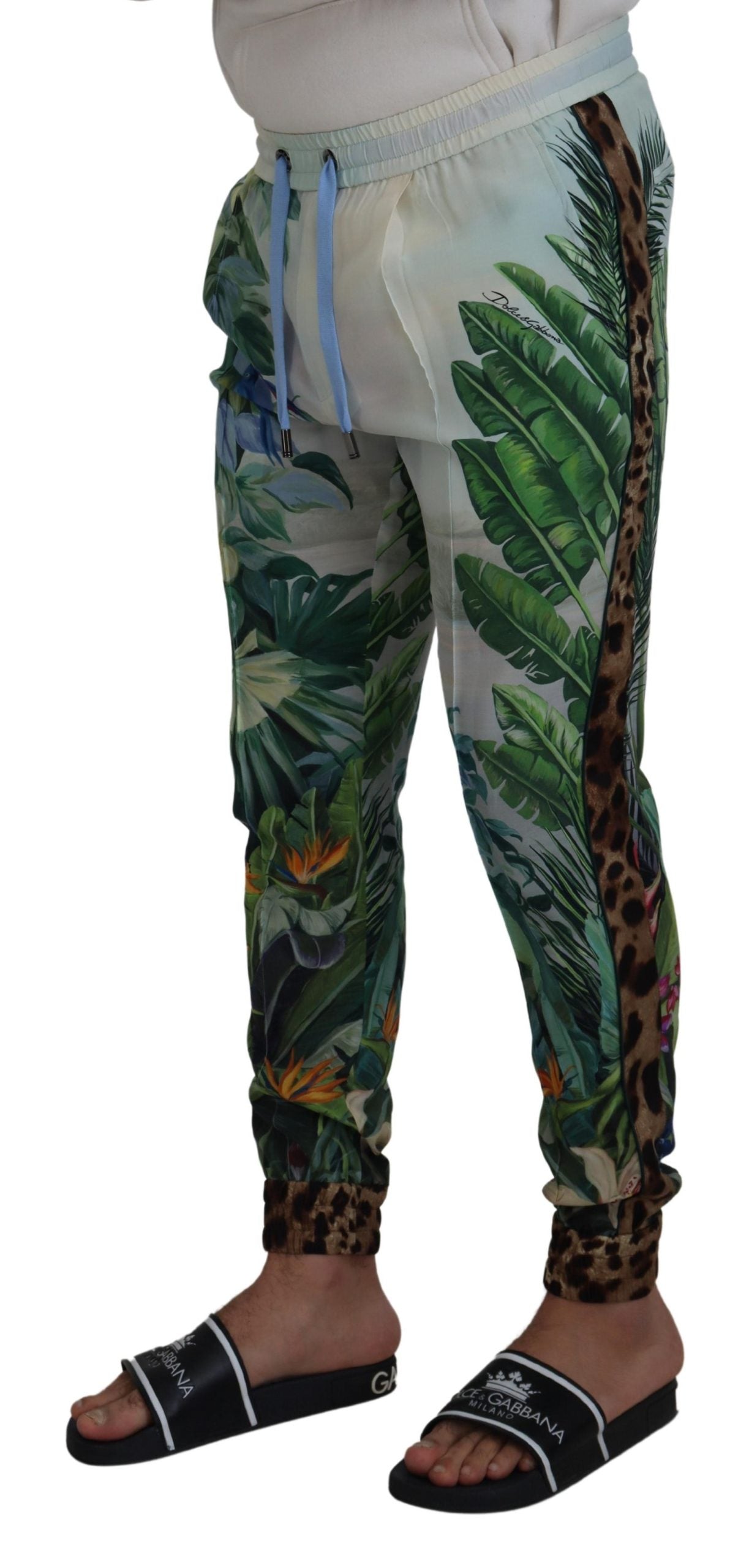 White floral printed men's jogger pants by Dolce & Gabbana, featuring a comfortable fit and stylish floral design.