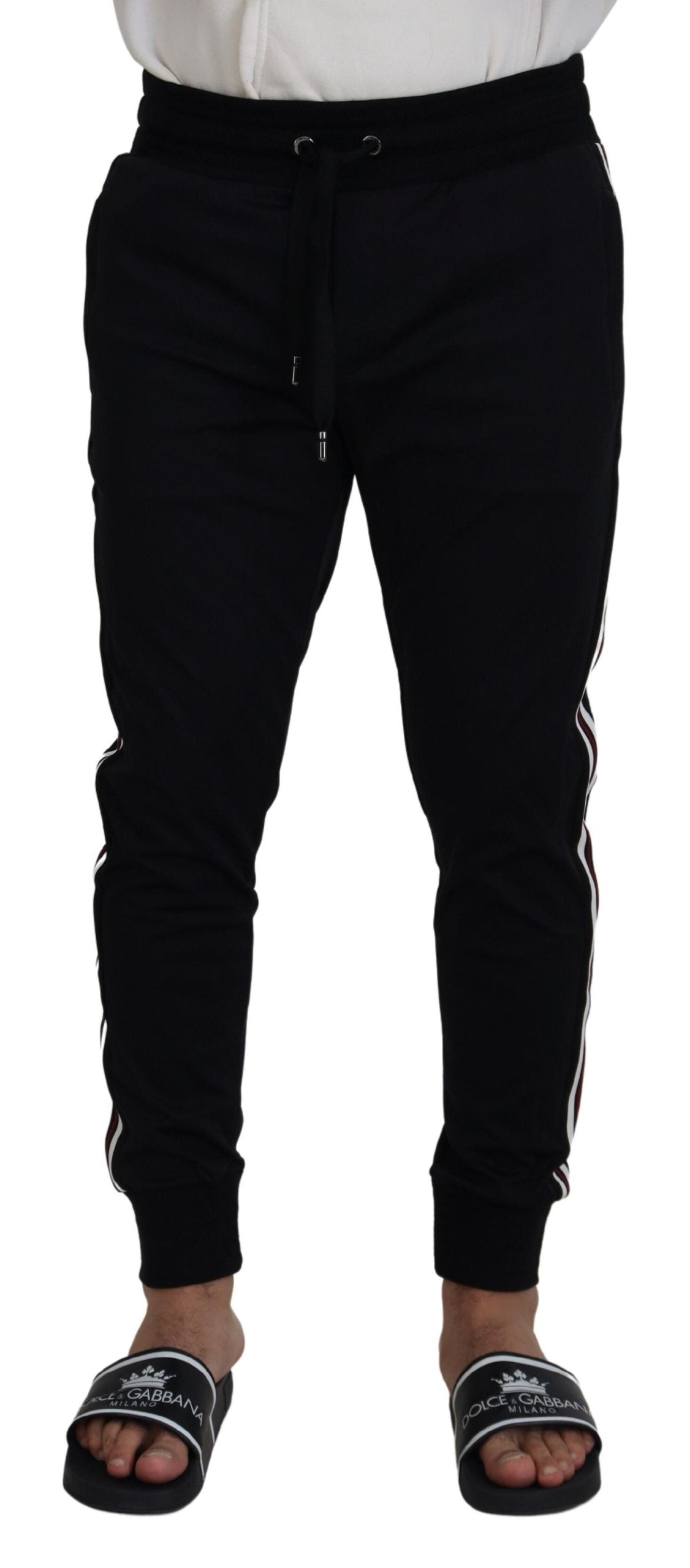 Black Dolce & Gabbana men's jogger pants with DG print, featuring a relaxed fit and elastic waistband.