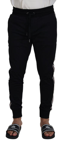 Black Dolce & Gabbana men's jogger pants with DG print, featuring a relaxed fit and elastic waistband.