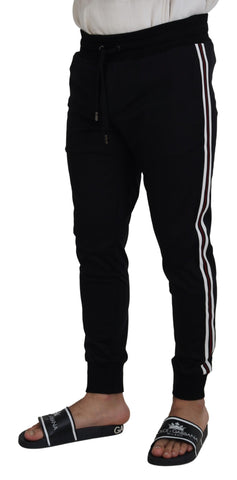 Black DG print men's jogger pants by Dolce & Gabbana with tapered fit and elastic waistband, casual streetwear style.