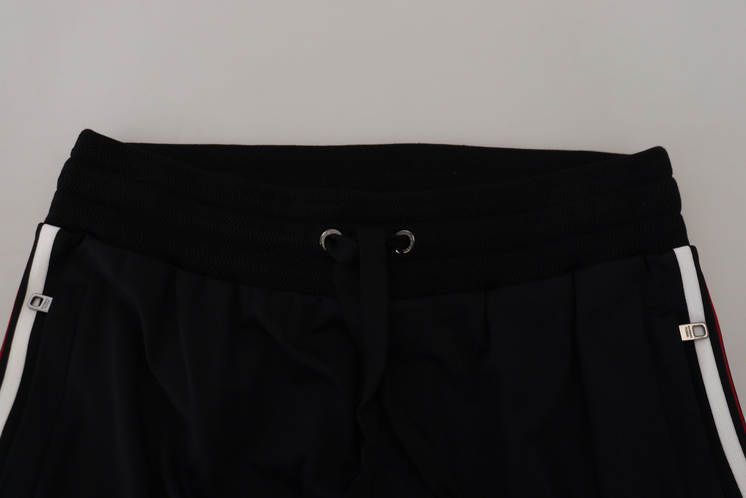 Black Dolce & Gabbana men's jogger pants with DG print, featuring a relaxed fit and elastic waistband.