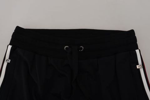 Black Dolce & Gabbana men's jogger pants with DG print, featuring a relaxed fit and elastic waistband.