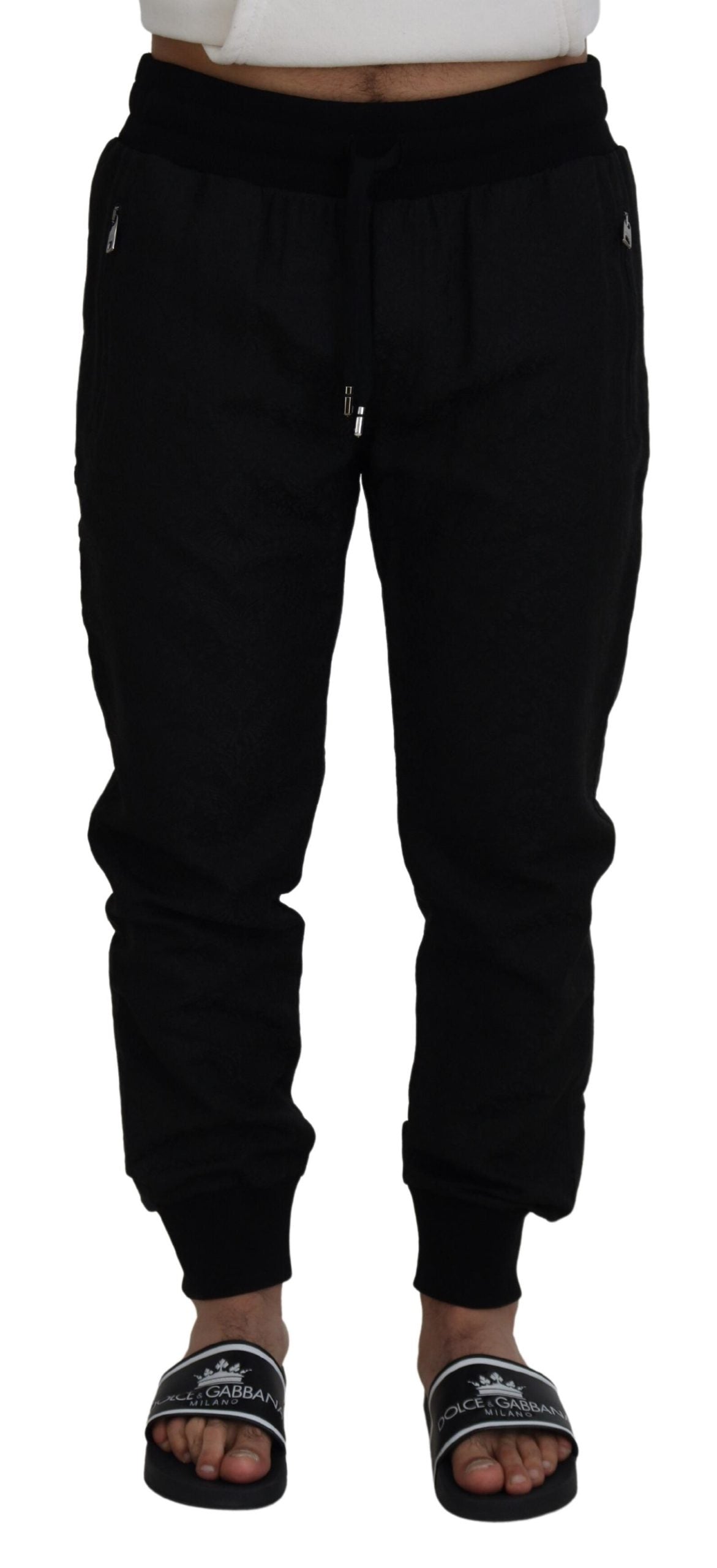 Black men's casual jogger pants by Dolce & Gabbana, shown with a relaxed fit and elastic waistband, styled for everyday wear.