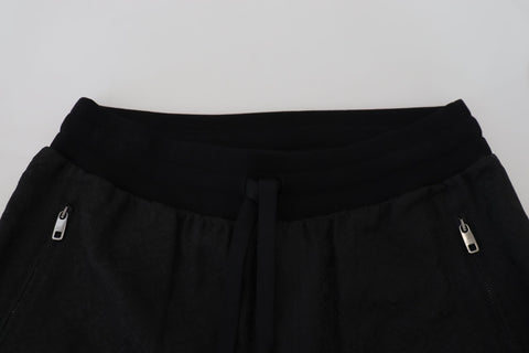 Black men's casual jogger pants by Dolce & Gabbana, featuring a relaxed fit and elastic waistband, shown on a model.
