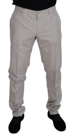Dolce & Gabbana off white silk mid waist chino pants displayed on a hanger with front pockets and tailored fit.