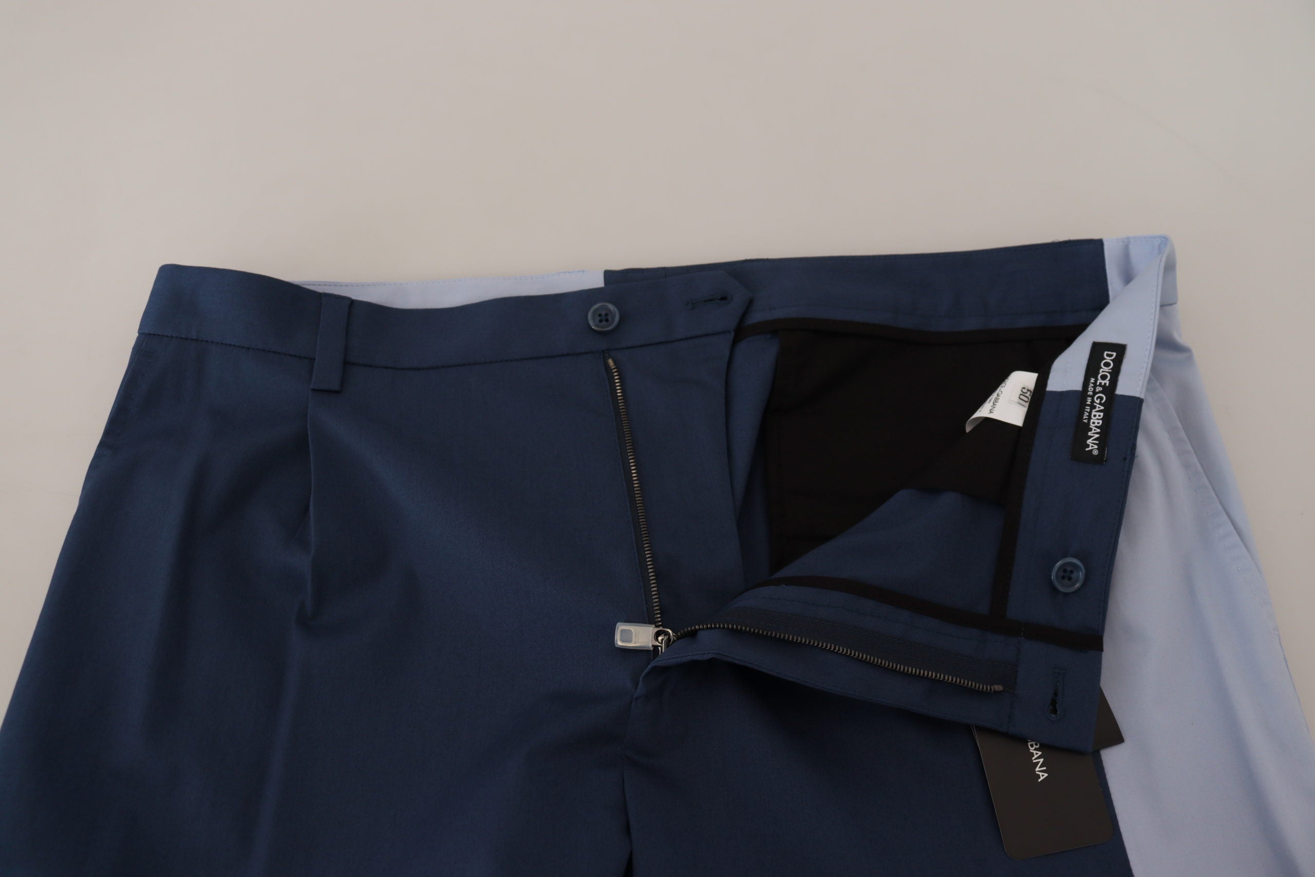 Blue cotton straight fit pants by Dolce & Gabbana, shown on a model, with a focus on the tailored design and fabric texture.