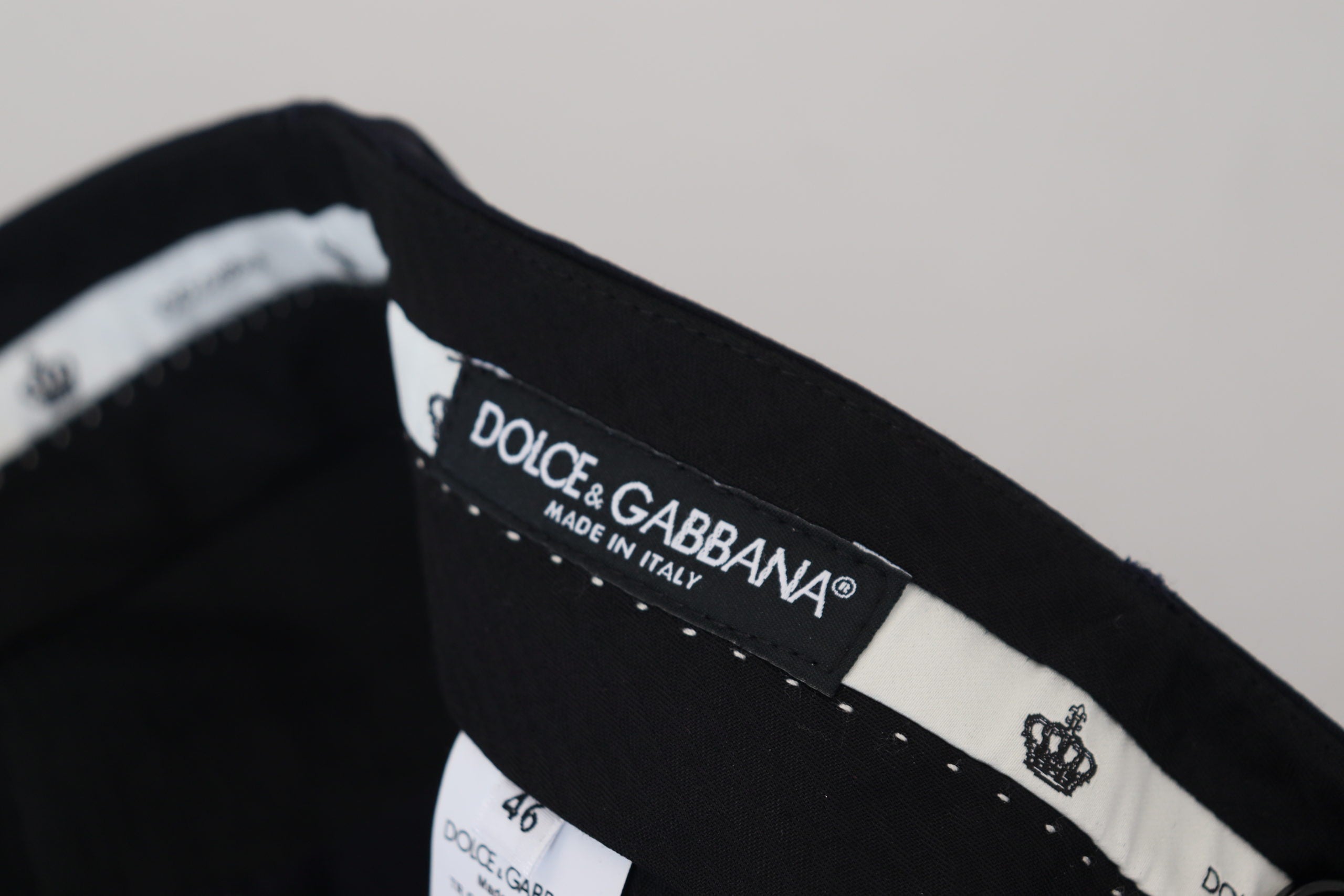 Black wool slim formal pants by Dolce & Gabbana, featuring tailored fit and classic design on a plain background.