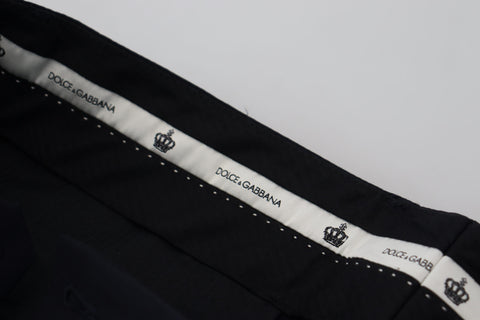 Black wool slim formal pants by Dolce & Gabbana, tailored fit with sleek design, shown on a hanger against a neutral background.