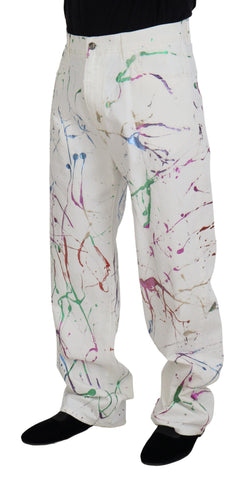 White cotton denim pants with colorful splash print by Dolce & Gabbana, featuring a relaxed fit and stylish design.