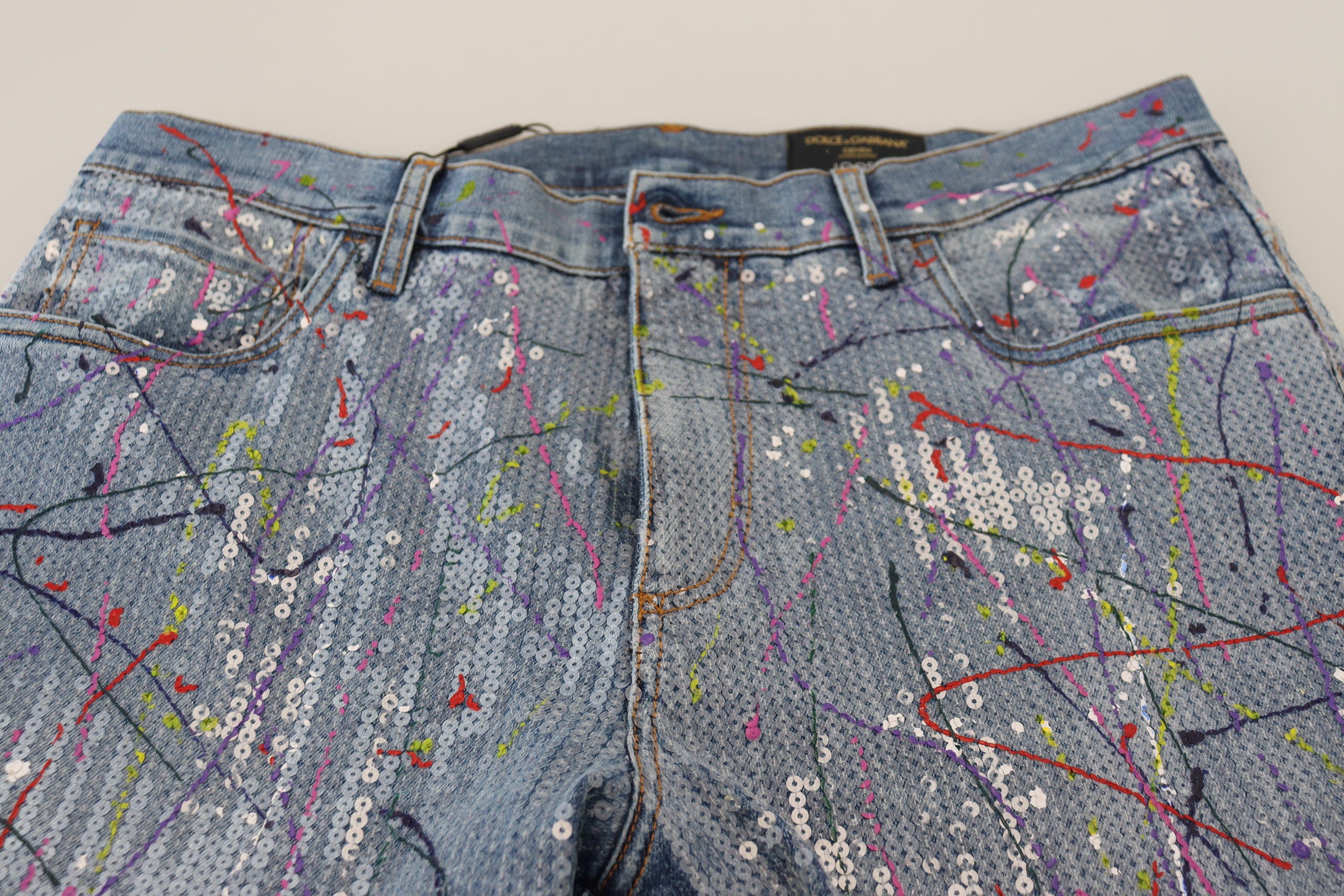 Blue cotton denim jeans with colorful splash print from Dolce & Gabbana, showcasing a stylish and vibrant design.