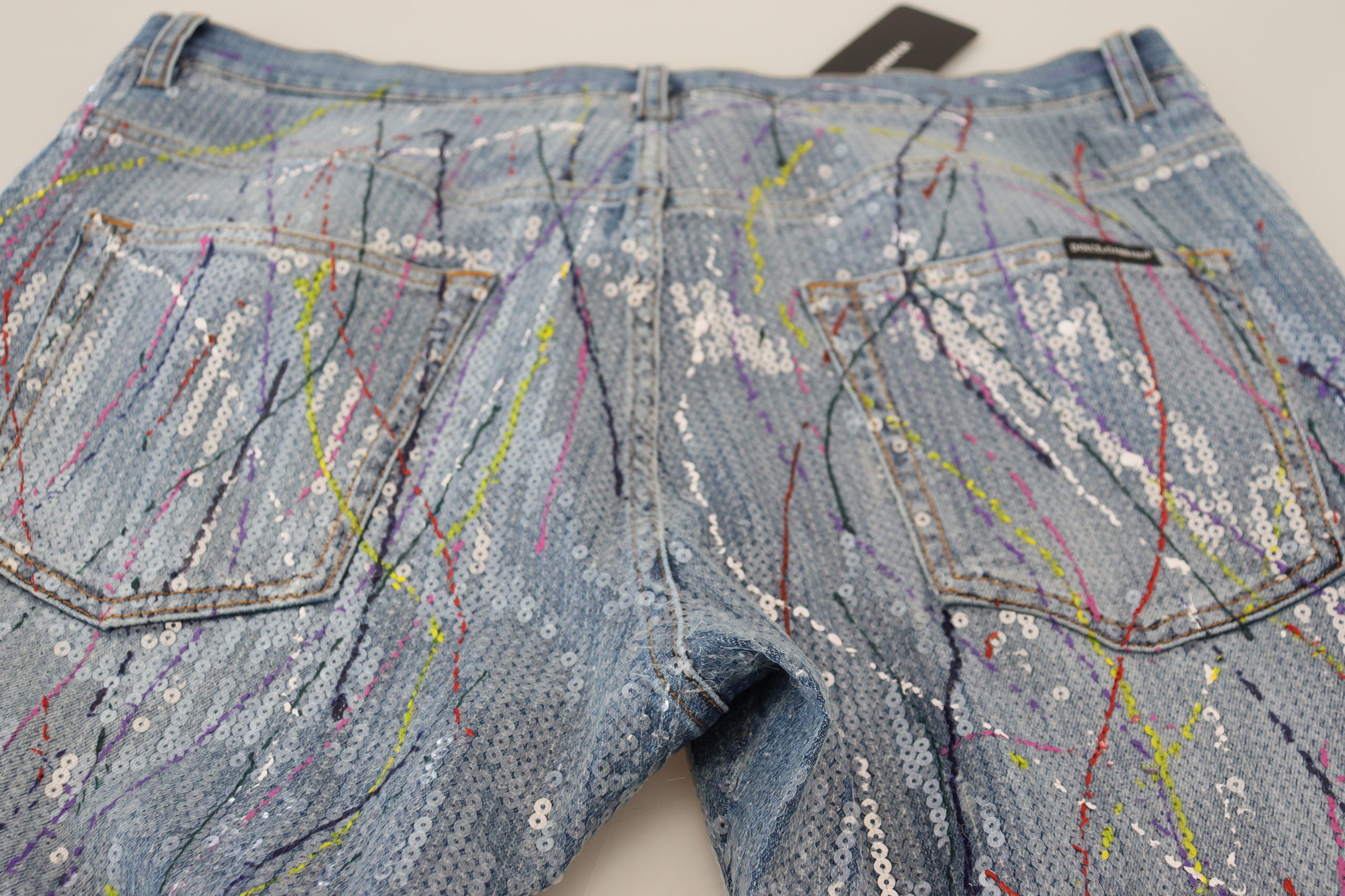 Blue cotton denim jeans with colorful splash print by Dolce & Gabbana, featuring classic five-pocket design and relaxed fit.