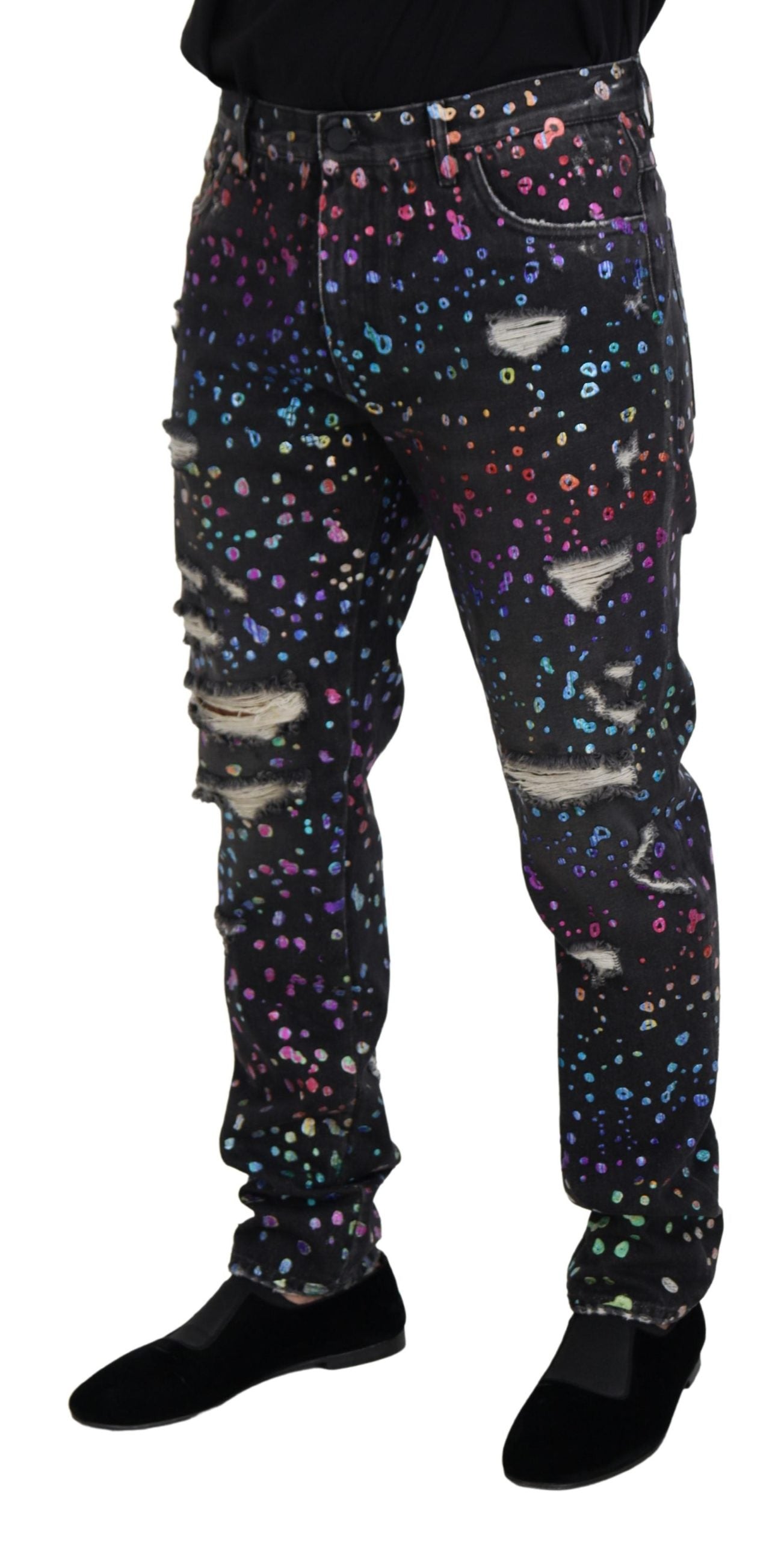 Black multicolor print tattered denim jeans by Dolce & Gabbana with distressed details and vibrant multicolor pattern.