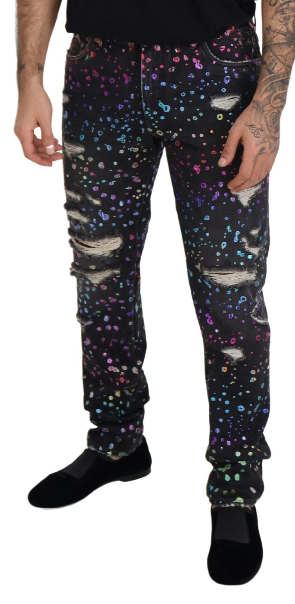 Black multicolor print tattered denim jeans by Dolce & Gabbana with distressed details and vibrant pattern accents.