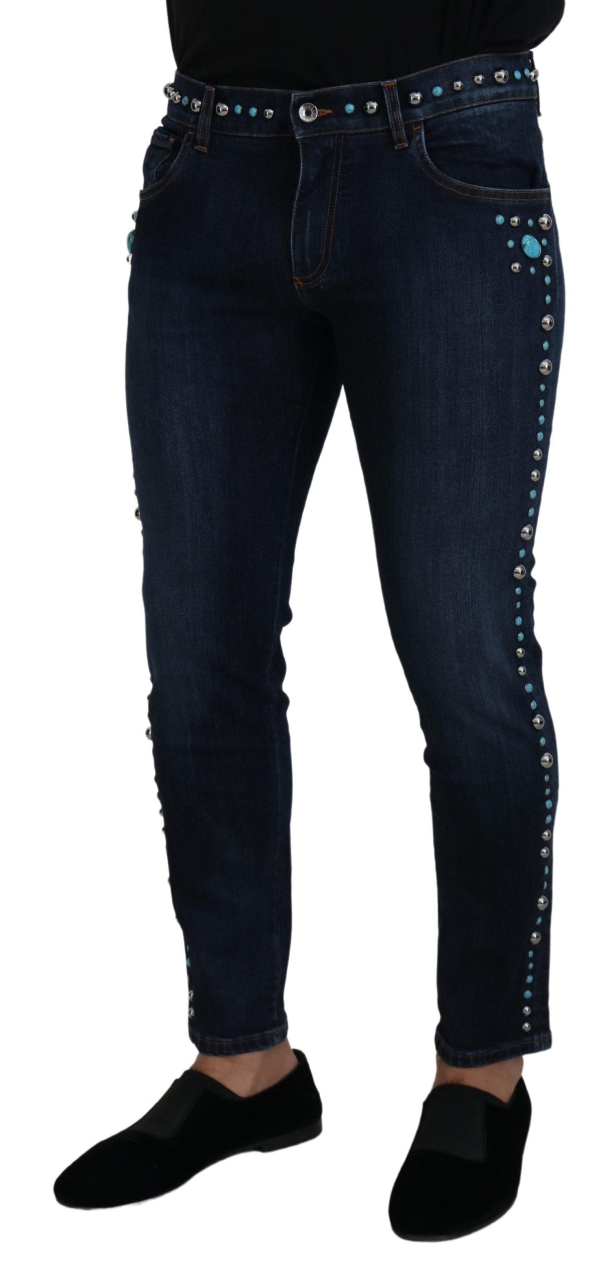 Blue cotton denim jeans with studded details, low waist style by Dolce & Gabbana, shown with front view and belt loops.