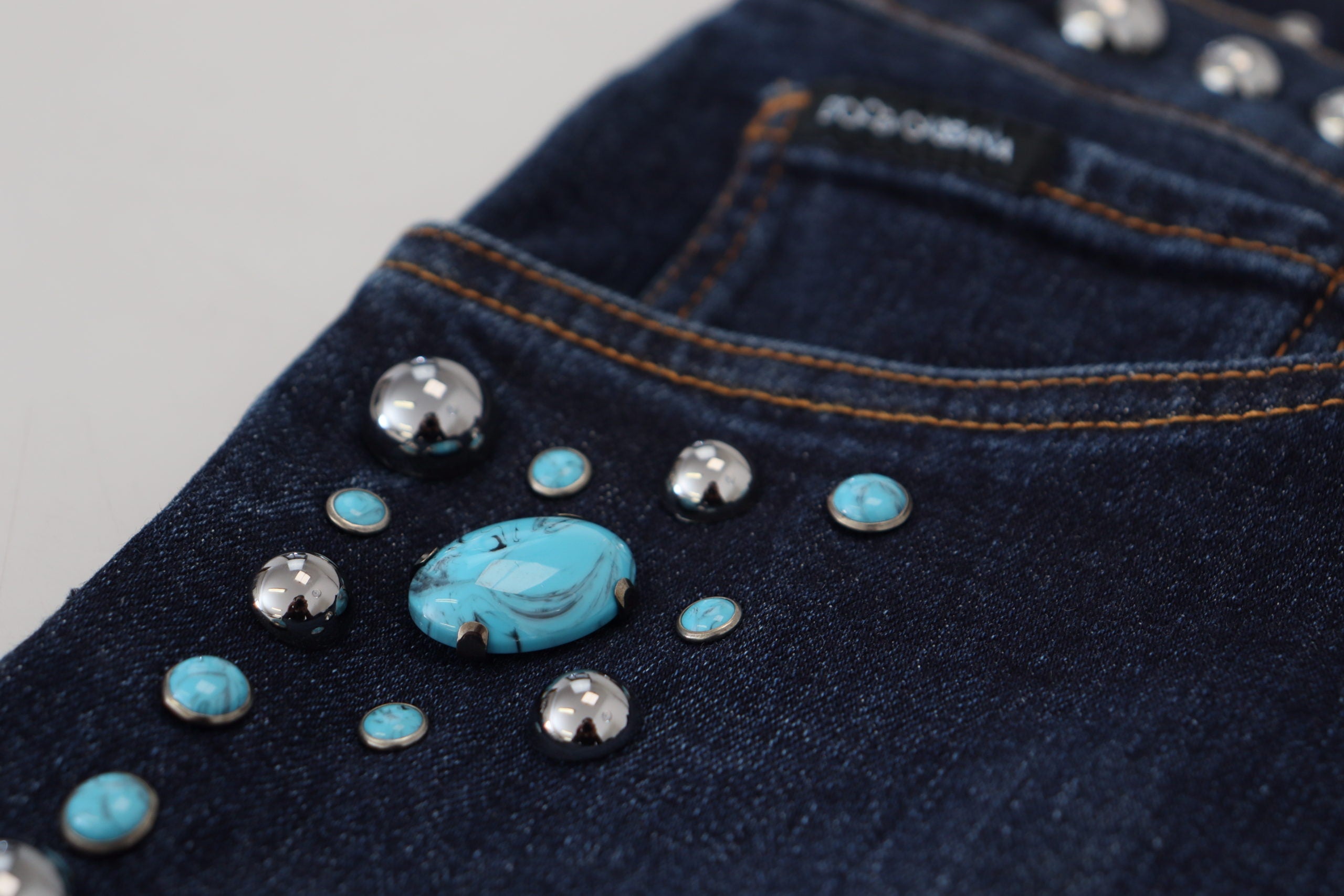 Blue cotton studded low waist denim jeans by Dolce & Gabbana, featuring a fitted design and stylish studded accents.