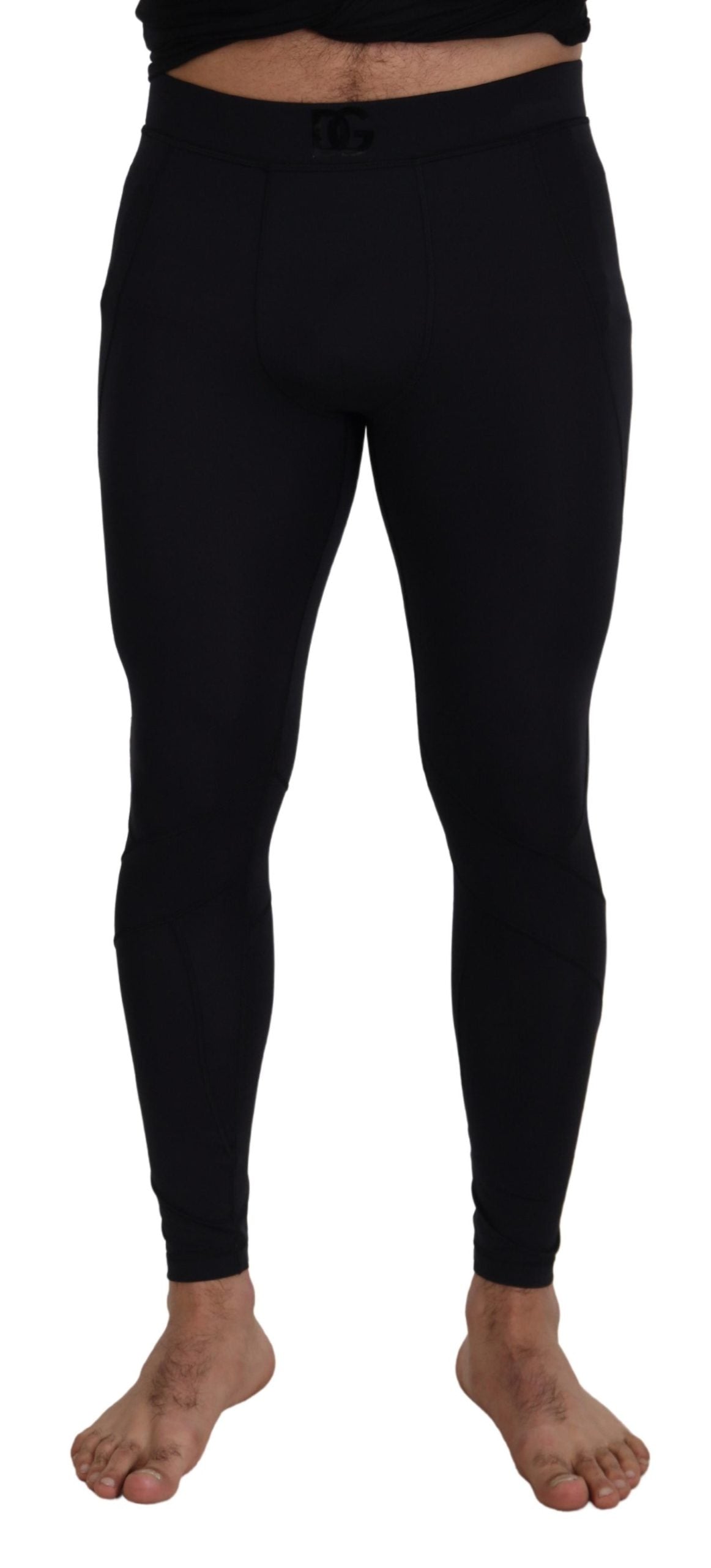 Black nylon slim fit stretch pants by Dolce & Gabbana, showing the sleek design and tailored fit on a mannequin.