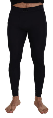 Black nylon slim fit stretch pants by Dolce & Gabbana, showing the sleek design and tailored fit on a mannequin.
