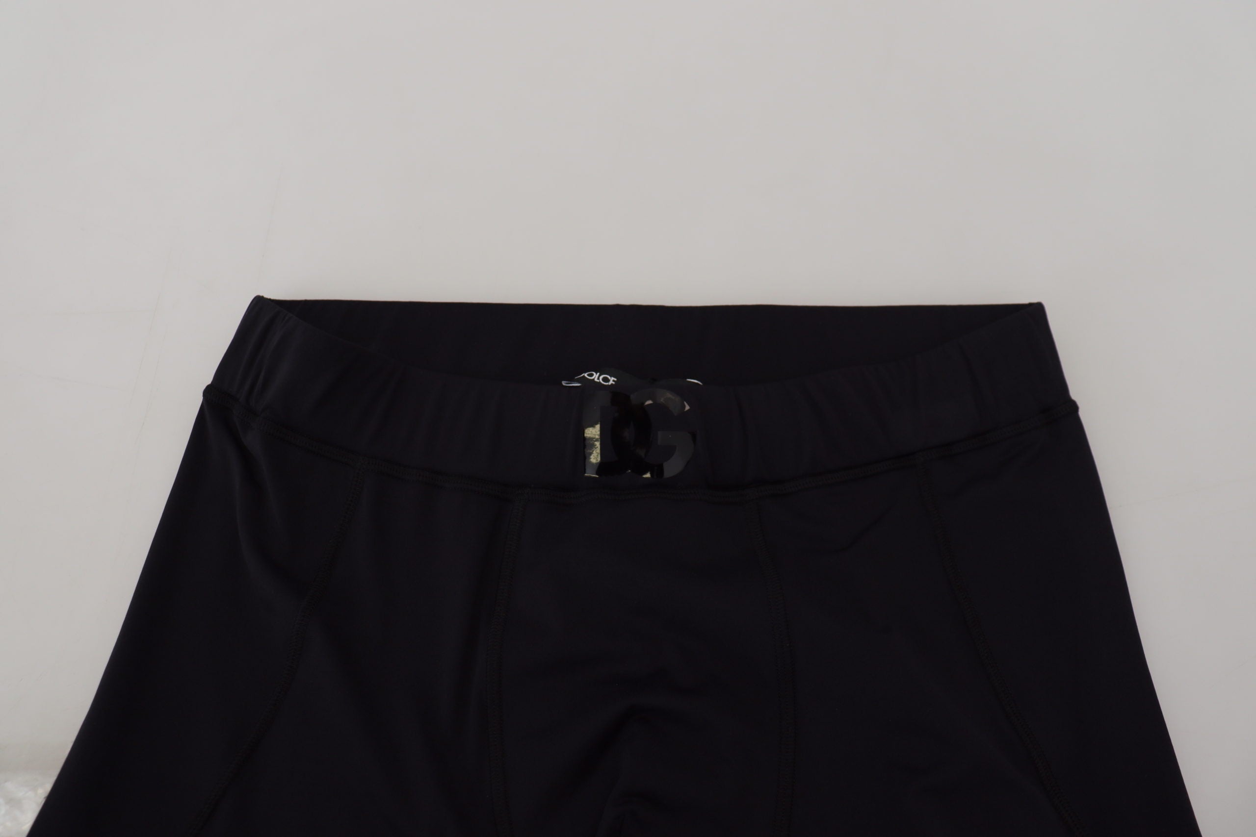 Black nylon slim fit stretch pants by Dolce & Gabbana, showing the sleek, fitted design and smooth fabric texture.