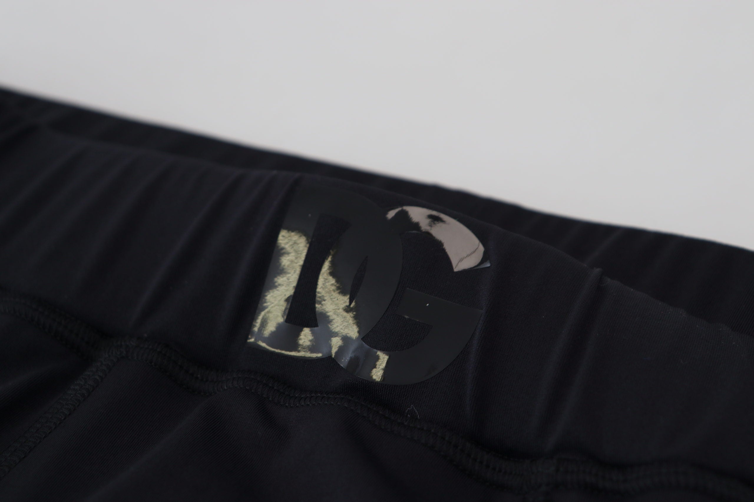 Black nylon slim fit stretch pants by Dolce & Gabbana, showing the sleek design and tailored fit.