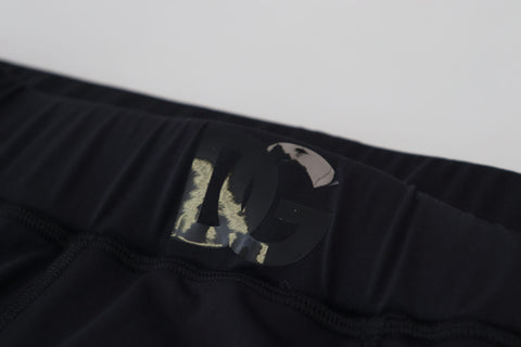 Black nylon slim fit stretch pants by Dolce & Gabbana, showing the sleek design and tailored fit.