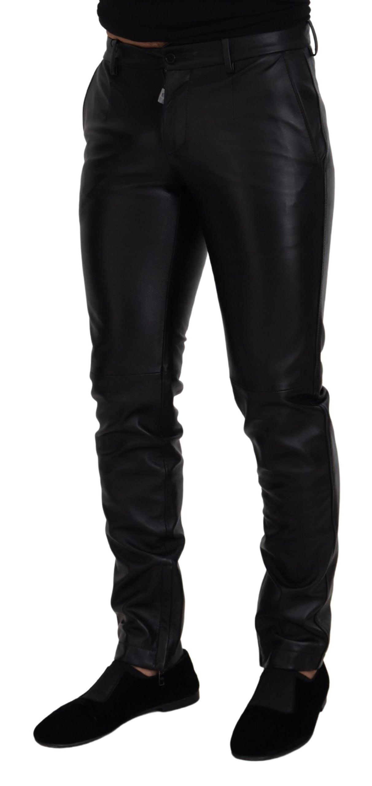 Black shiny stretch skinny pants by Dolce & Gabbana, close-up of fitted, sleek fabric with a high waist and smooth finish.