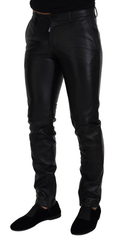 Black shiny stretch skinny pants by Dolce & Gabbana, close-up of fitted, sleek fabric with a high waist and smooth finish.
