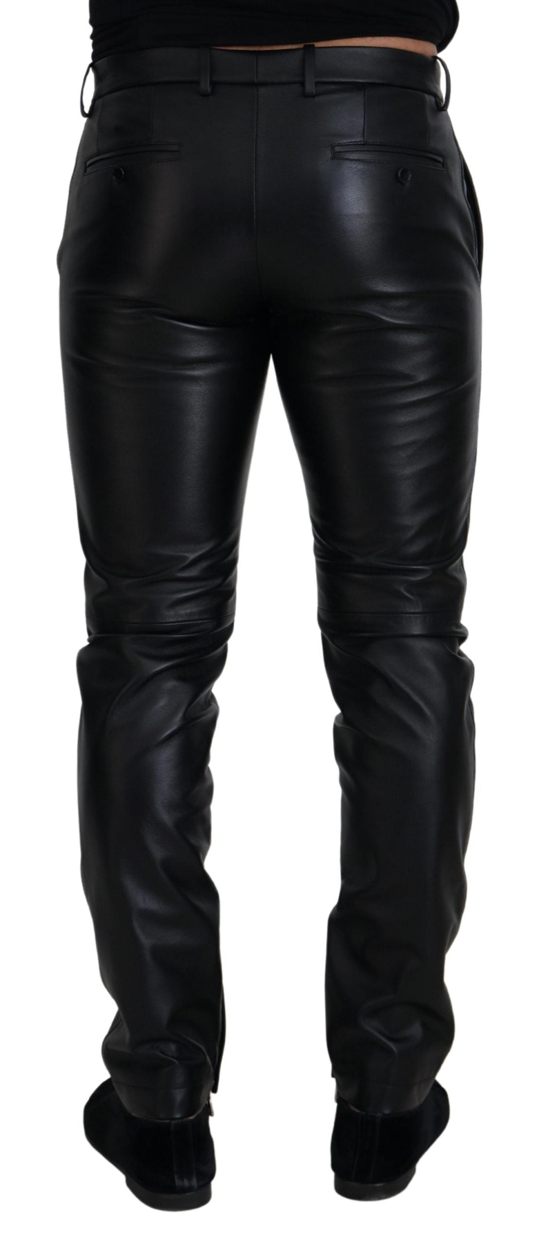 Black shiny stretch skinny pants by Dolce & Gabbana, showing a close-up of the sleek, fitted fabric and stylish design.