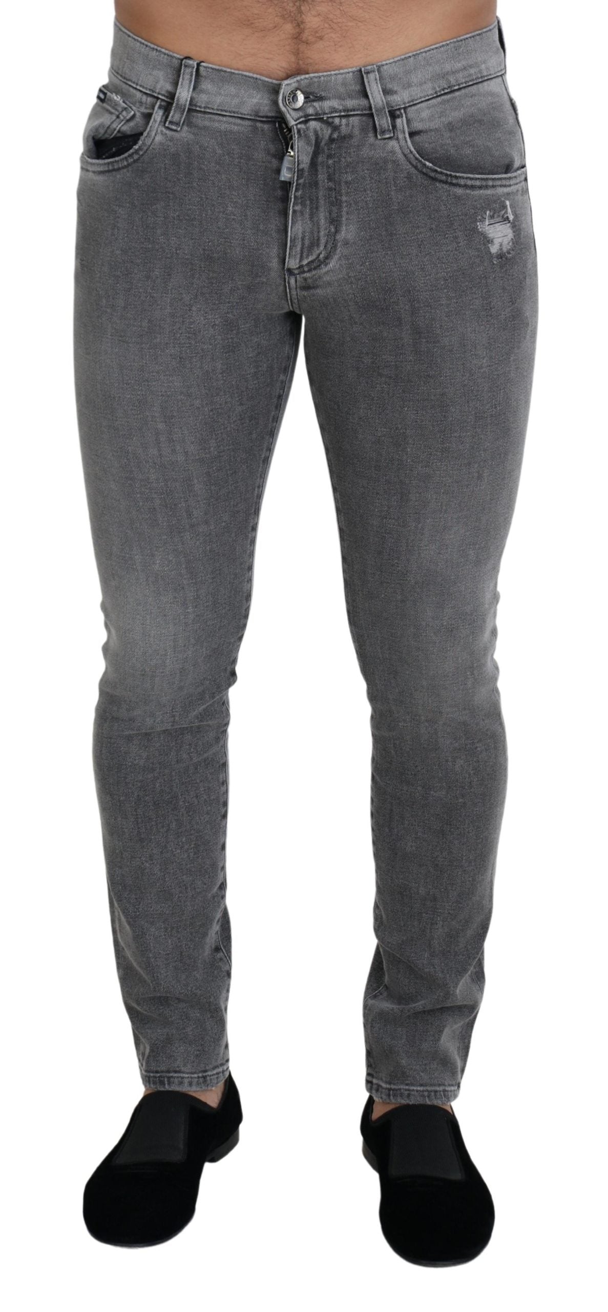Grey washed cotton skinny denim jeans by Dolce & Gabbana, showing close-up of fitted style and distressed fabric detail.