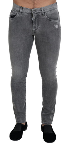 Grey washed cotton skinny denim jeans by Dolce & Gabbana, showing close-up of fitted style and distressed fabric detail.