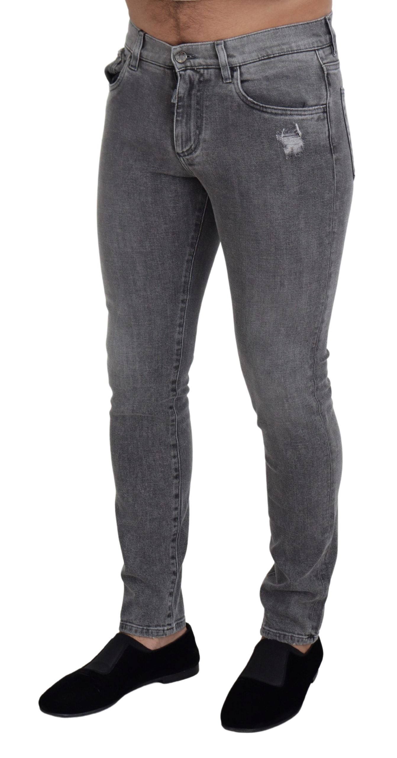 Grey washed cotton skinny denim jeans by Dolce & Gabbana, showing close-up of fitted style and distressed denim texture.