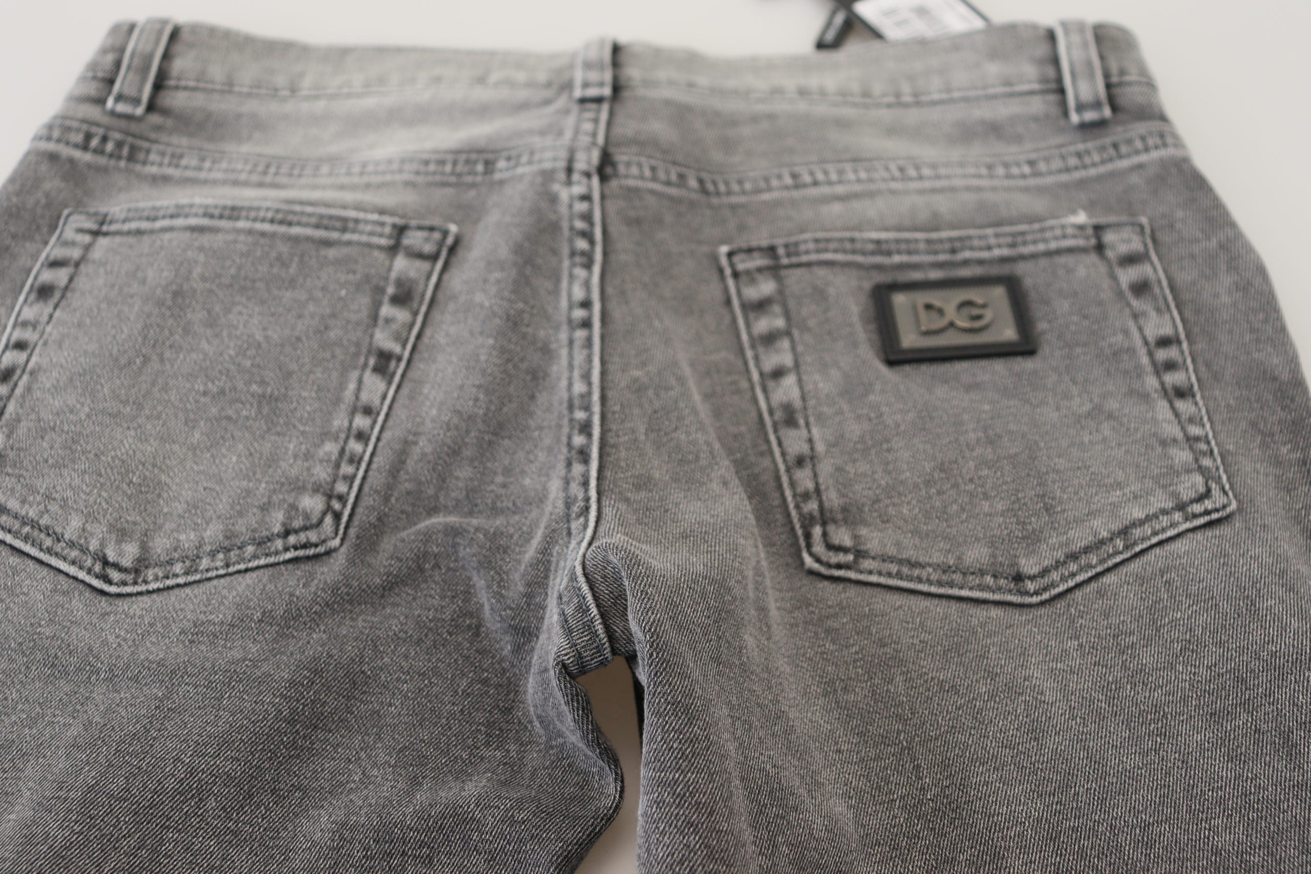 Gray washed cotton skinny denim jeans by Dolce & Gabbana, showing a close-up of the fitted jeans with faded detailing.