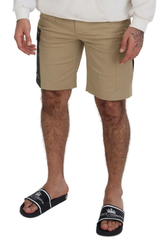 Beige cotton cargo Bermuda shorts by Dolce & Gabbana, featuring multiple pockets and a relaxed fit, shown on a model.